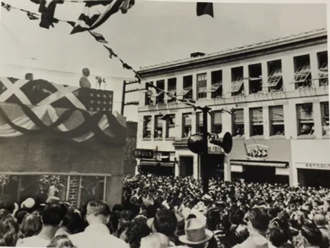 Black and white photograph of Harry S. Truman speaking to a crowd from the balcony of the Elks building in Bremerton, WA.