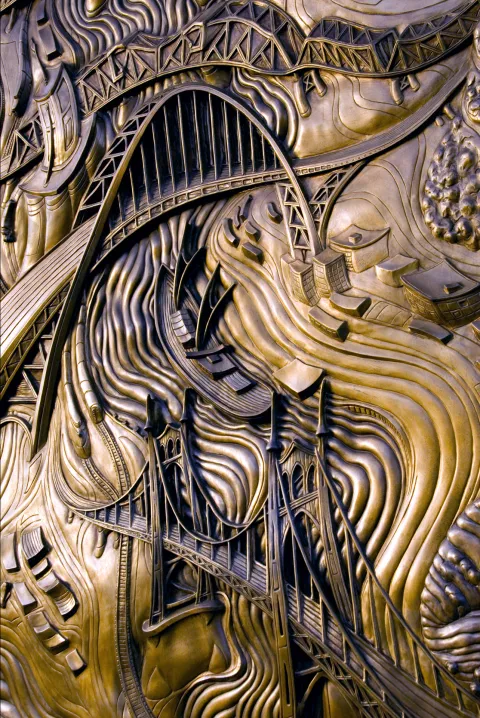 Close up shot of detail of Connections bronze panel