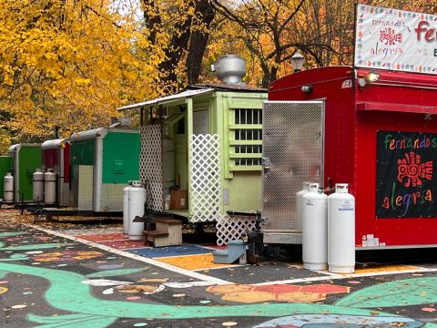 food carts lined up in a parking lot in autumn