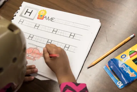 child writing at school