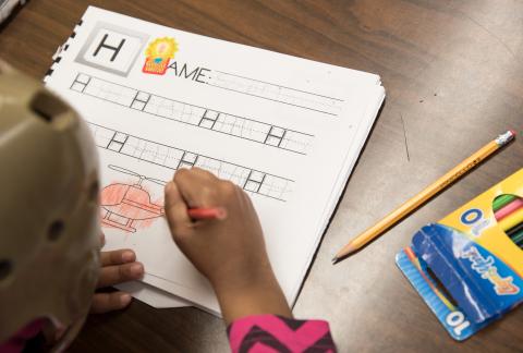 child writing at school