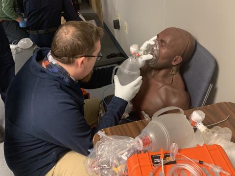 A paramedic trainee is practicing providing oxygen