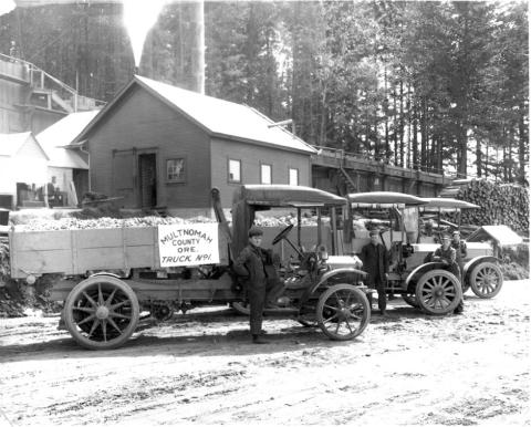 Three 1930s gravel trucks in front of the County road shop on Rocky Butte.