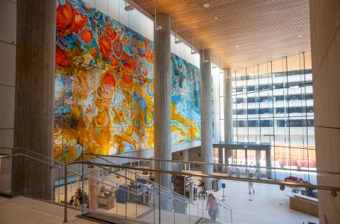 Just inside the three-story atrium, visitors are greeted by a 75-by-25 foot, kiln-formed glass art installation — inspired by the variety of people who pass through the courthouse doors and their myriad journeys.