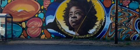 Colorful wall mural featuring a portrait of Amanda S.C. Gorman, National Youth Poet Laureate.