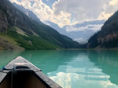 A canoe in Lake Louise in front of mountains in Banff National Park, Canada