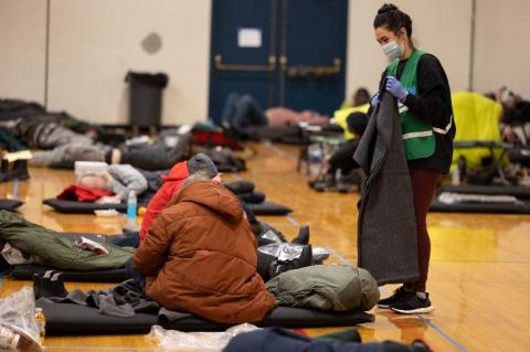 Shelter worker offers blanket