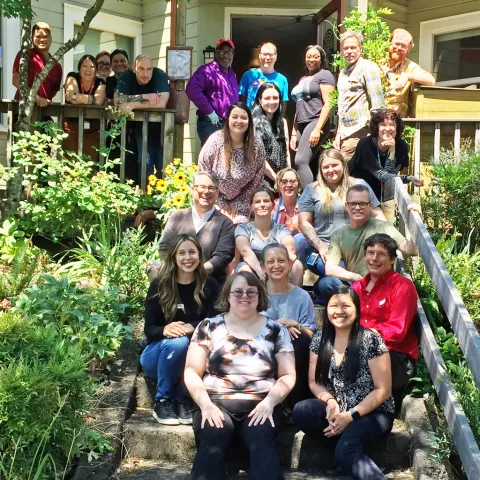 Portland's Ryan White HIV Services Planning Council staff and volunteers gather on a front porch.