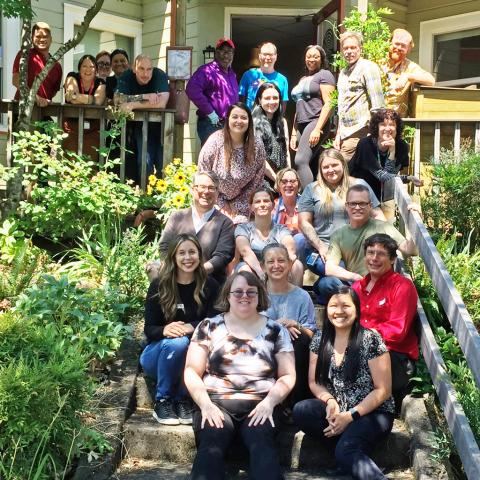 Portland's Ryan White HIV Services Planning Council staff and volunteers gather on a front porch.