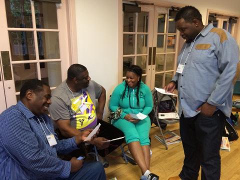 Black people in a small group discussion at a community health worker training.