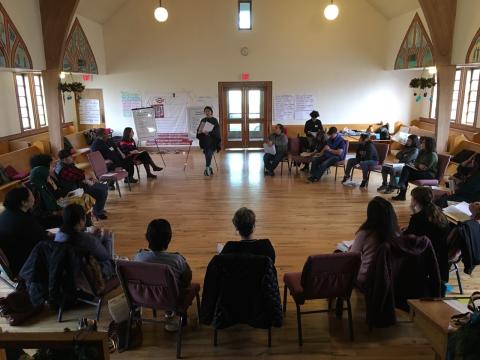 People sitting in a circle at a popular education training in a local church. 