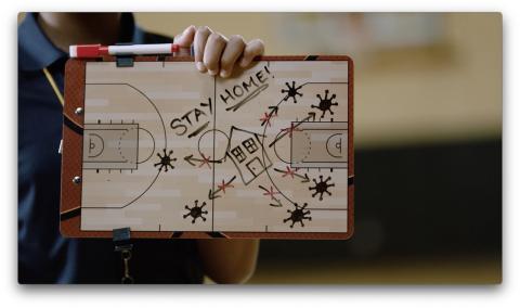 Stay home! Basketball tactic board showing players blocking virus germs from home at center court.