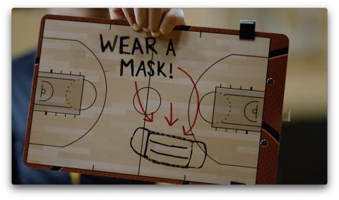 Wear a mask! Basketball tactic board showing red arrows pointing to a face mask.