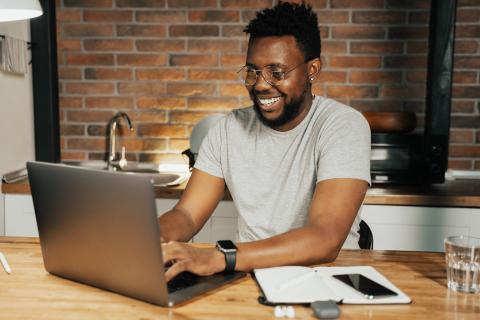 Man views a meeting on his computer