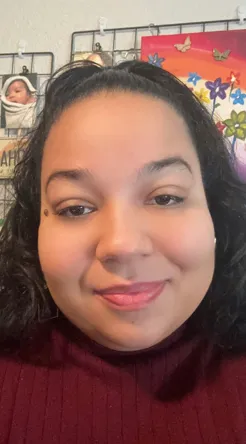 woman with short brown hair and burgundy top