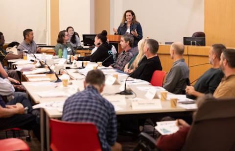 A meeting around a conference table of the Community Design Advisory Group (CDAG).