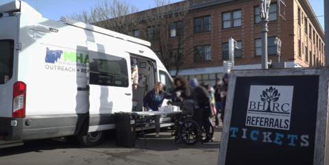 People gathering around the Behavioral Health Resource Center's street outreach van in Portland Oregon.