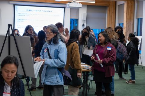 People gather at the Multnomah County Climate Justice Plan open house. Location: Holgate Library community room.