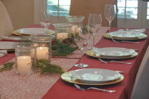 Holiday table setting with red tablecloth 