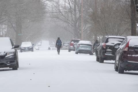 A person walks on a snowy road