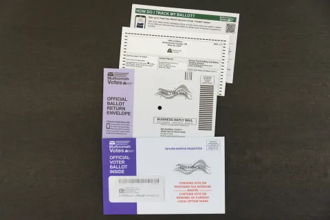 Multnomah County Elections' ballot packet content with tax message in red font