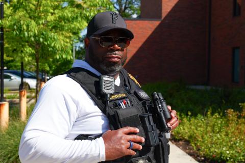 A Department of Community Justice Parole-Probation Officer poses in a tactical vest
