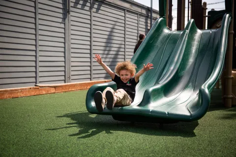 Happy child on slide