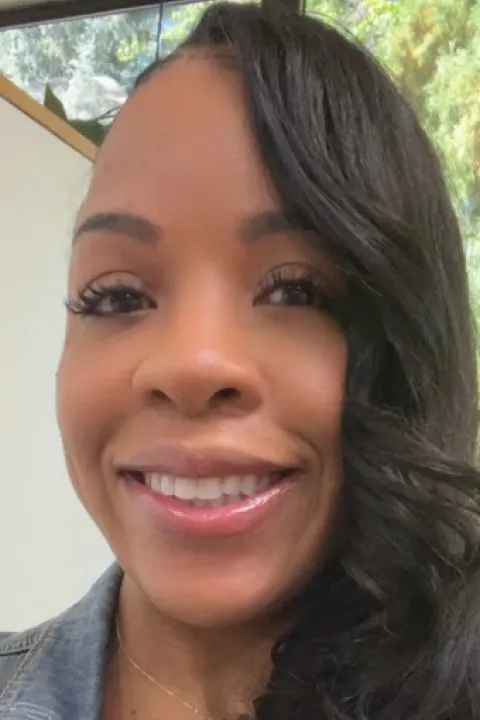 Yaisha smiling with a blue collared shirt on