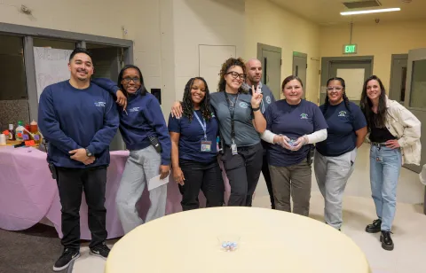 Eight Multnomah County juvenile custody staff at a family night event in detention